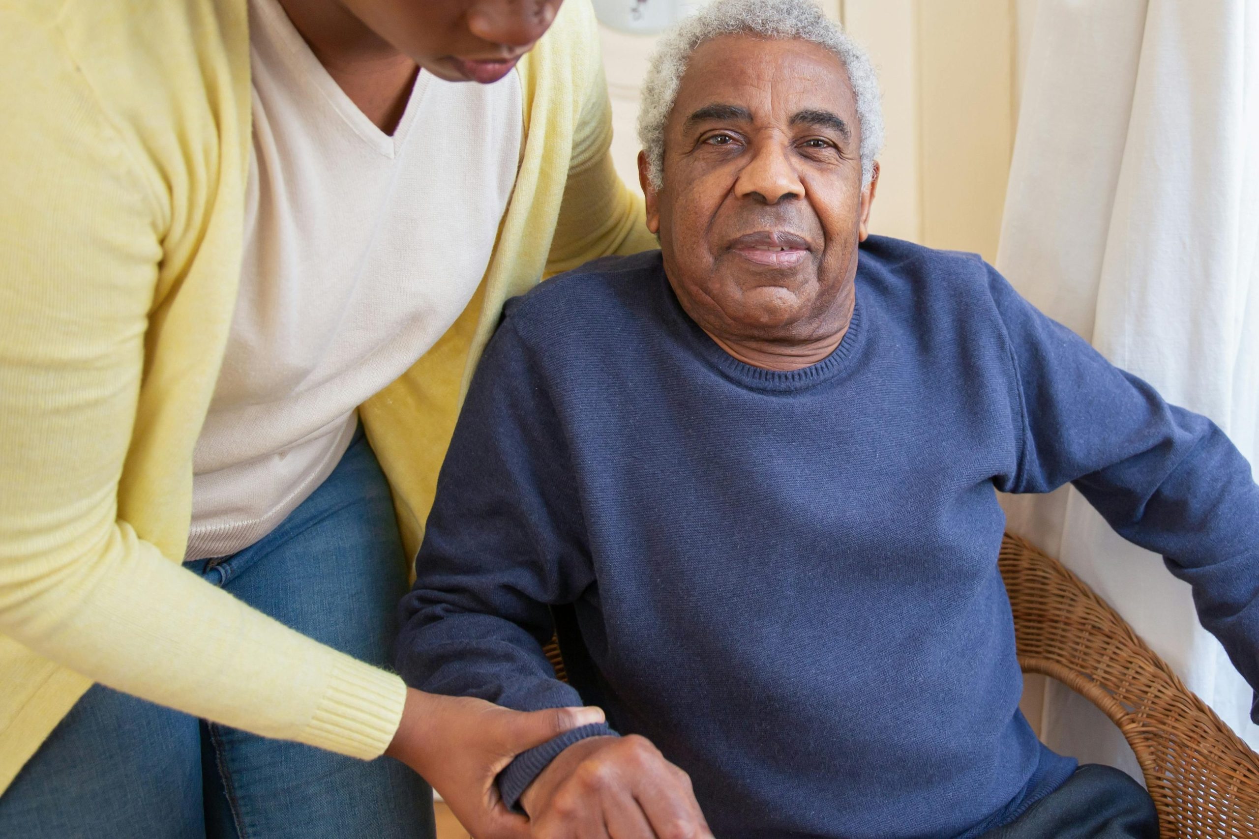 Occupational Therapy A woman assists an elderly man indoors, focusing on care and support.